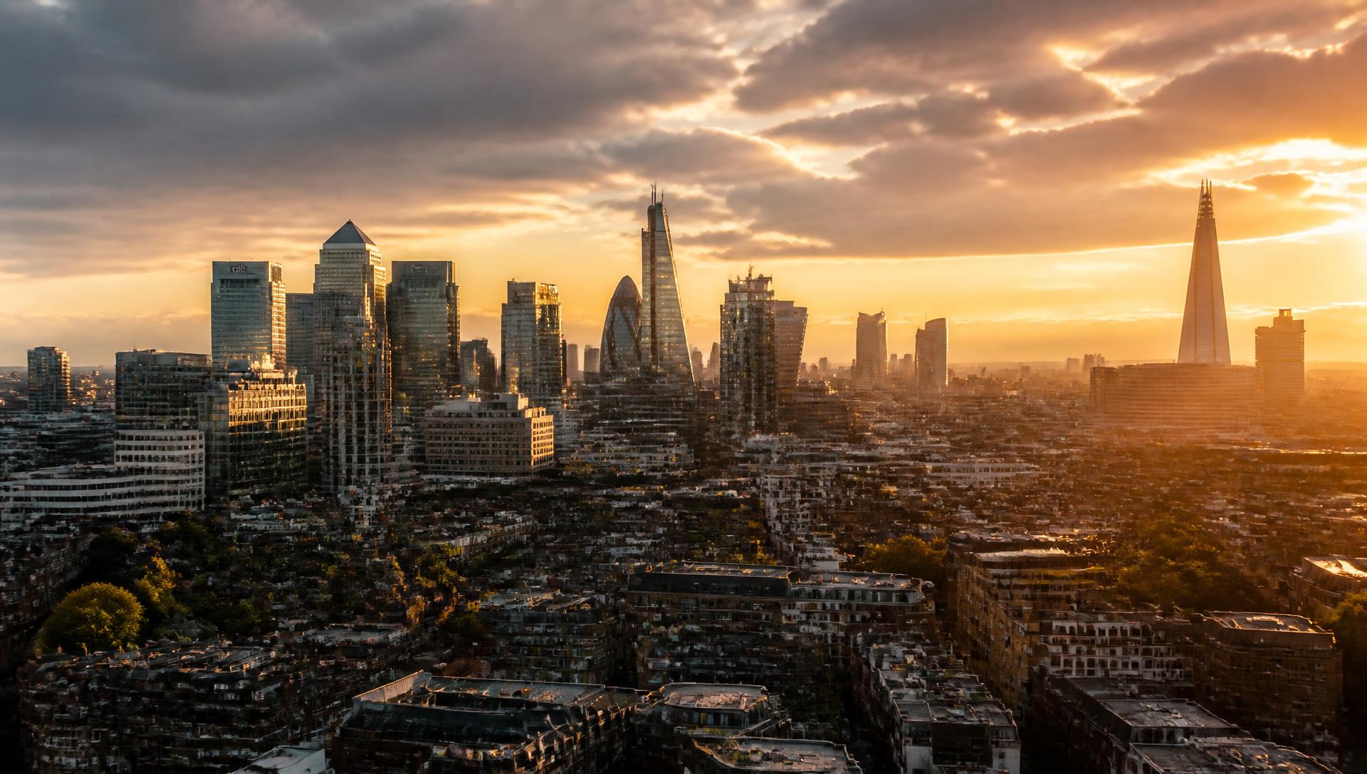 London skyline at golden hour with the City of London, Canary Wharf and The Shard